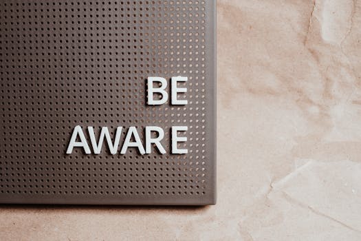 Be Aware wording on brown textured perforated surface, offering copyspace.